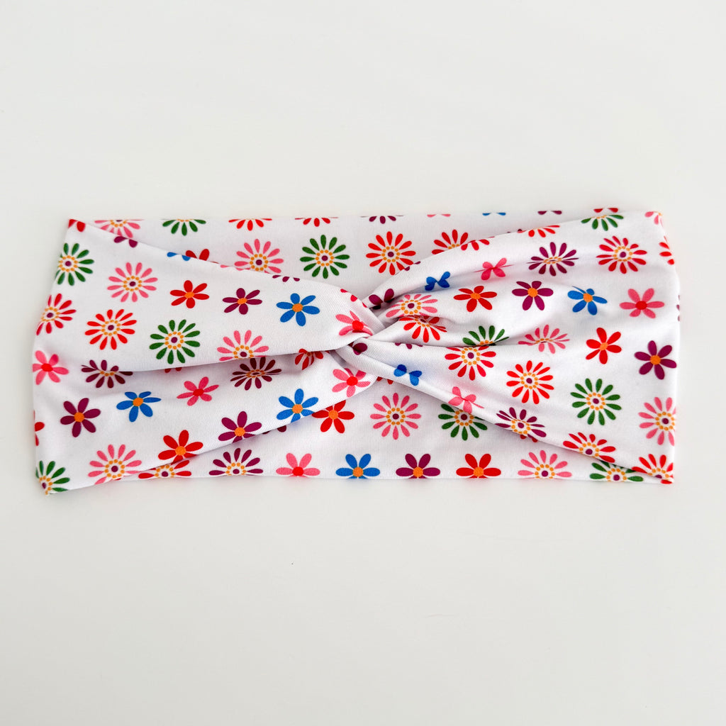 Colorful flowers Day of the Dead twist headband laid flat on white
