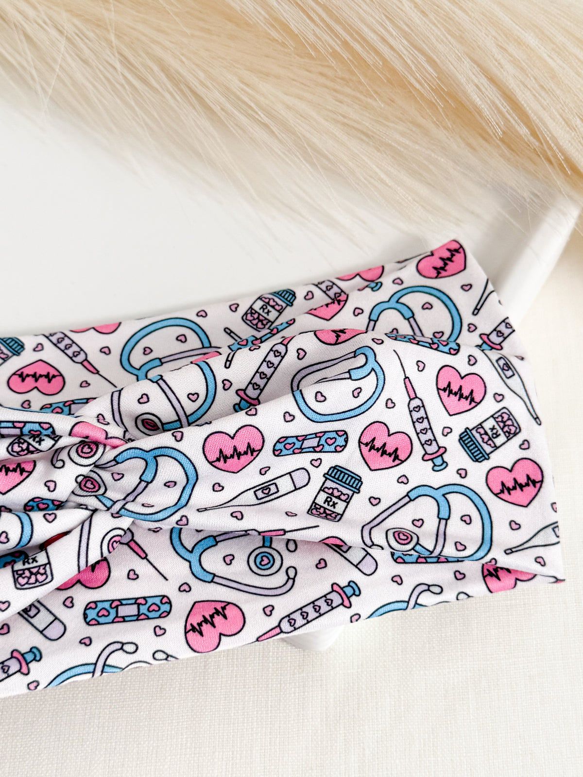 Pink twist headband for nurses – soft, non-slip, handmade by Headband Studio