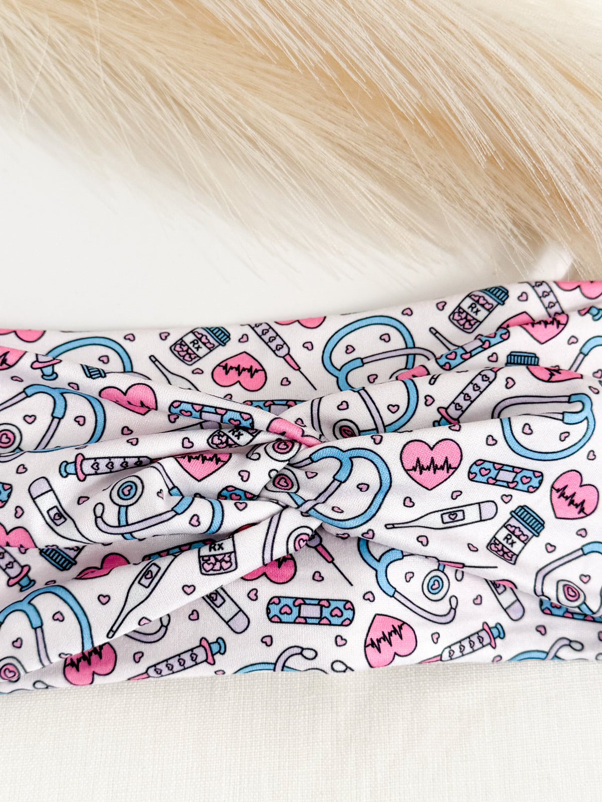 Pink twist headband for nurses – soft, non-slip, handmade by Headband Studio