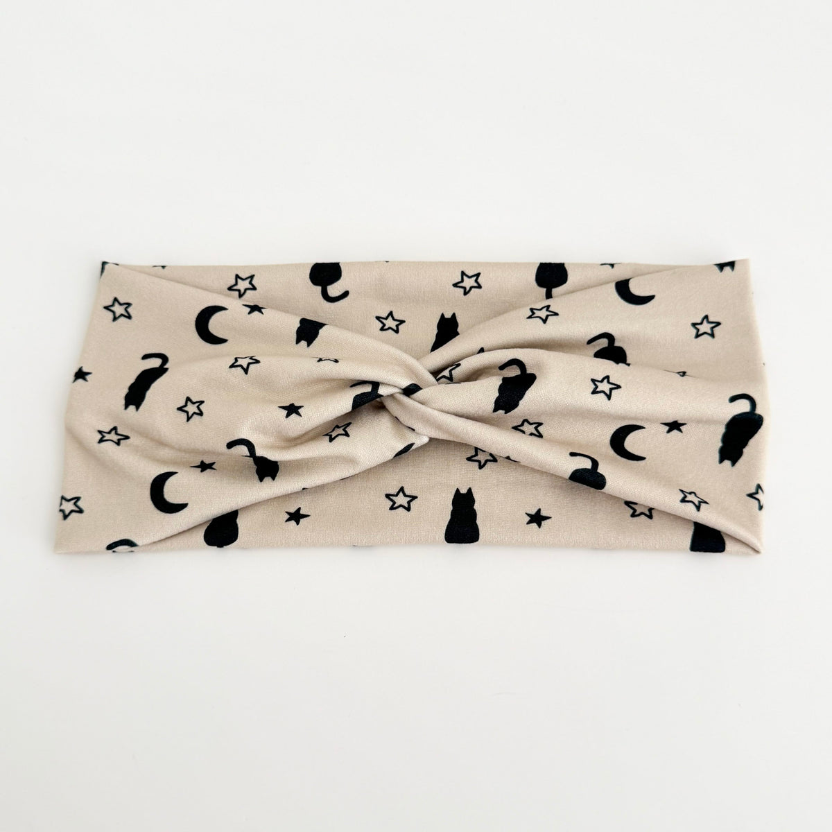 Black Cat and Moon twist headband with black cats, crescent moons and stars on cream