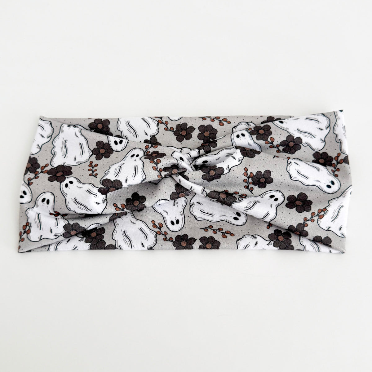 Ghostly Garden twist headband with white ghosts and black flowers on light gray