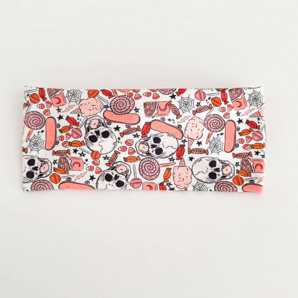 Back view of the Spooky Sweet Skulls knotted tie headband laid flat, showing the smooth back