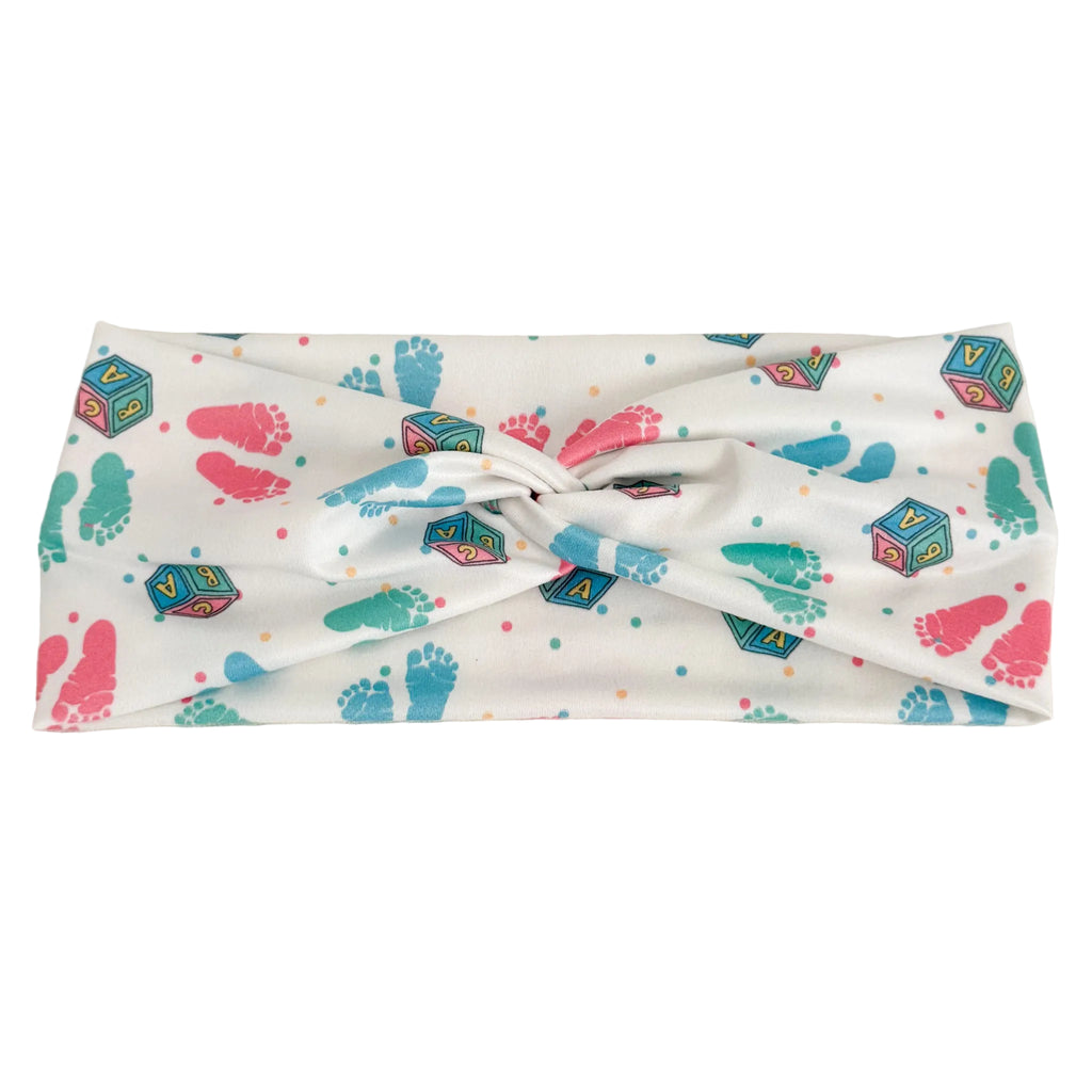 Headband with colorful baby footprint and block pattern on a white background