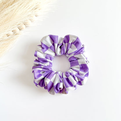 Purple and white checkered scrunchie on a light background