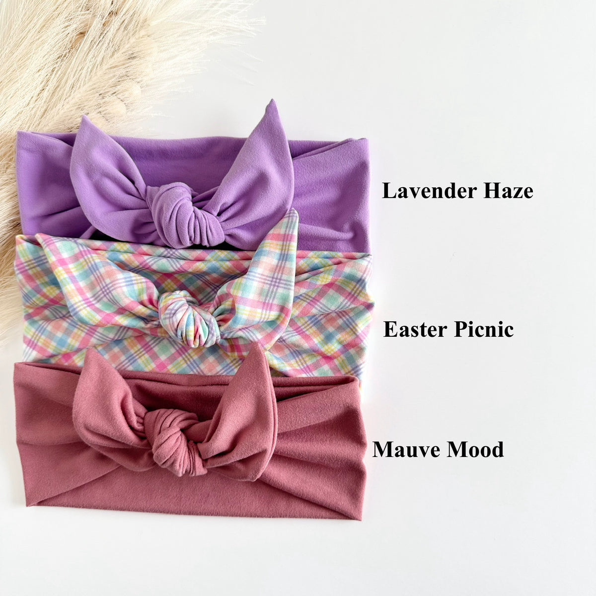 Headband Studio three soft tie headbands in Lavender Haze, Easter Picnic plaid, and Mauve Mood. Adjustable knot detail.