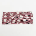 Pink Ghost twist headband with white ghosts and tiny flowers on dusty mauve
