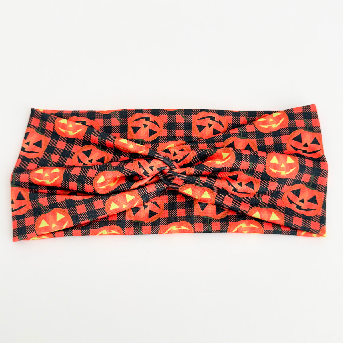 Plaid Pumpkin twist headband with jack-o'-lanterns on orange and black buffalo plaid