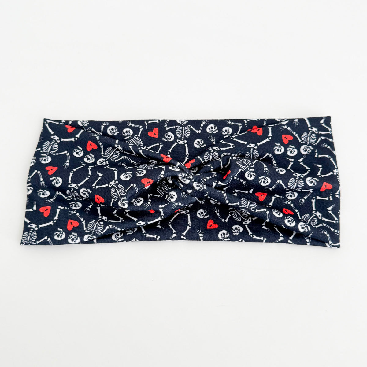Skeleton Sweethearts twist headband with dancing skeletons and red hearts on navy