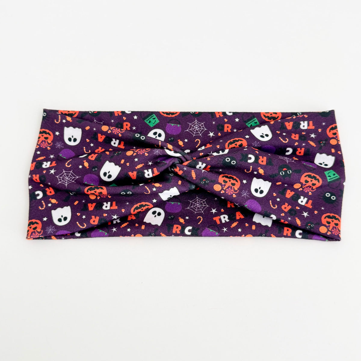 Trick or Treat Purple twist headband with ghosts, pumpkins and candy on purple