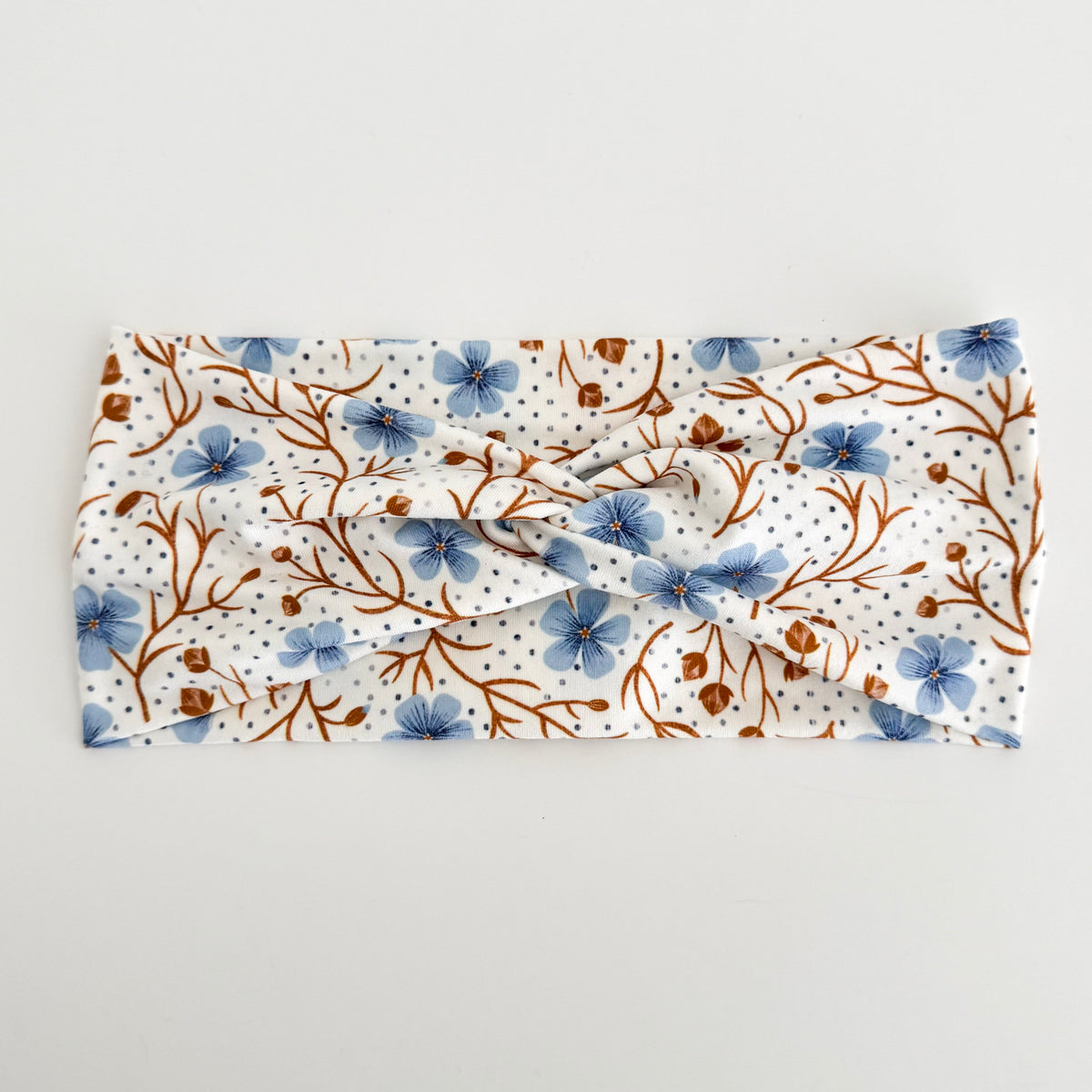 Blue Wildflower twist headband with blue flowers and brown branches on cream