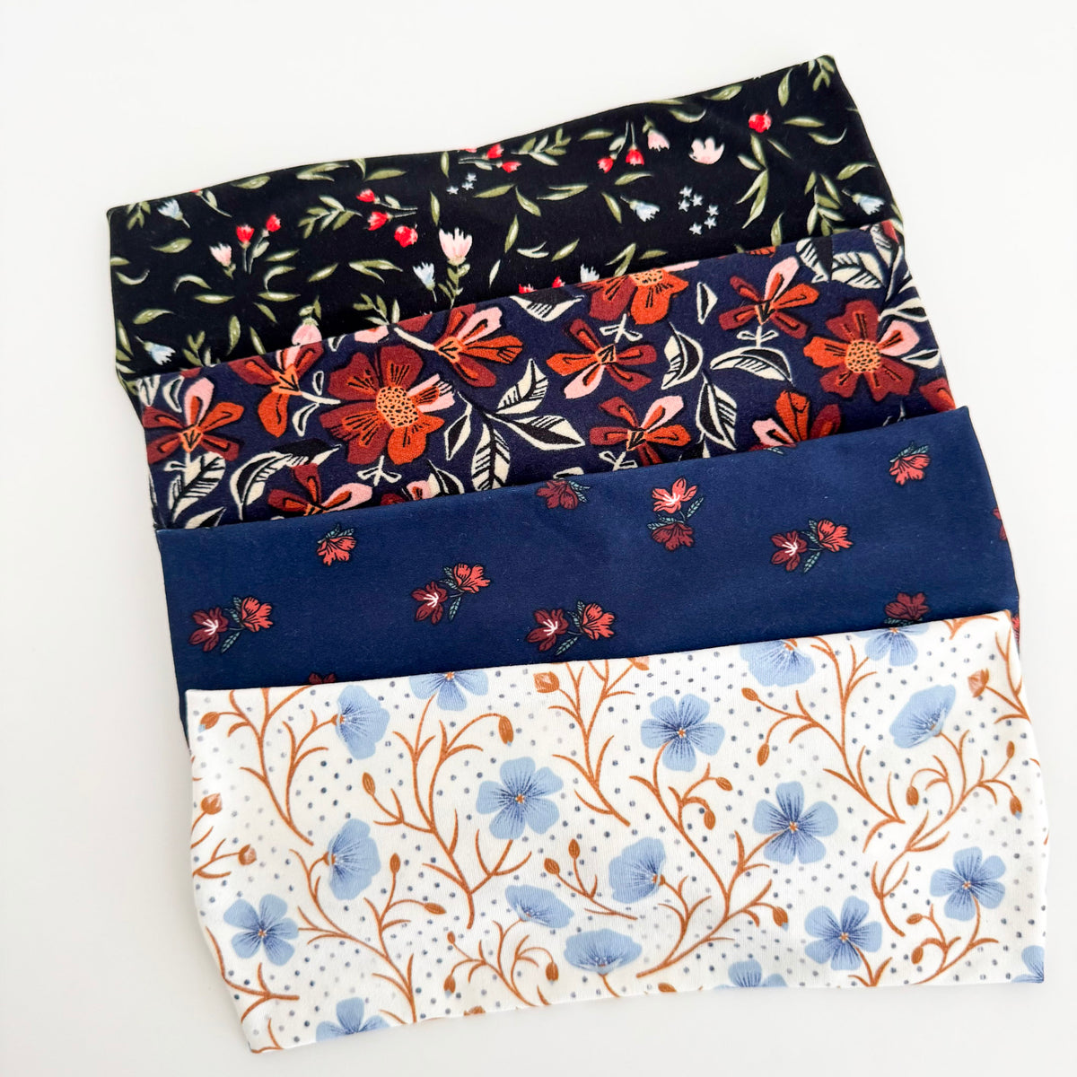 Fall floral twist headbands stacked: Midnight Blooms, Fall Floral, Navy Blossom and Blue Wildflower