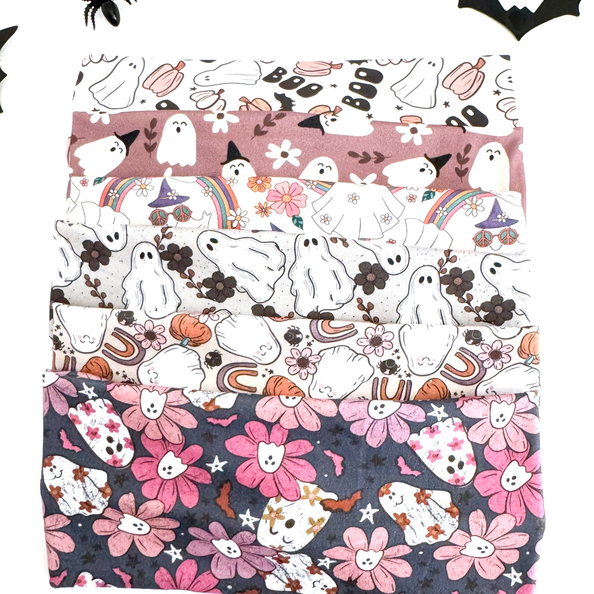 Ghost twist headbands stacked: Boo, Pink Ghost, Groovy Ghost, Ghostly Garden, Rainbow Ghost and Floral Ghost