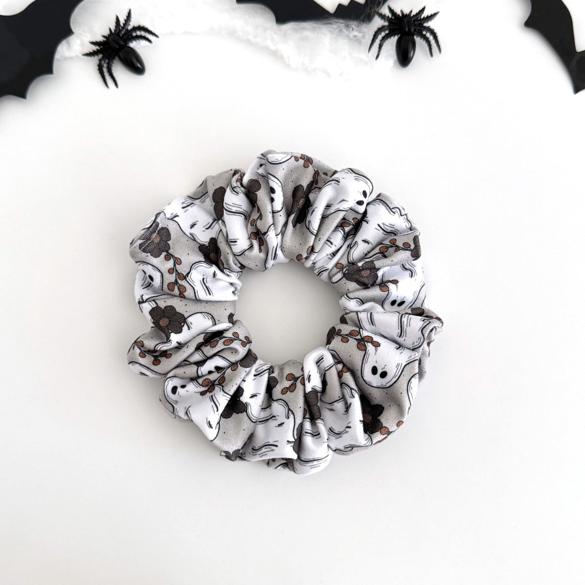 Ghostly Garden scrunchie with white ghosts and black flowers on light gray