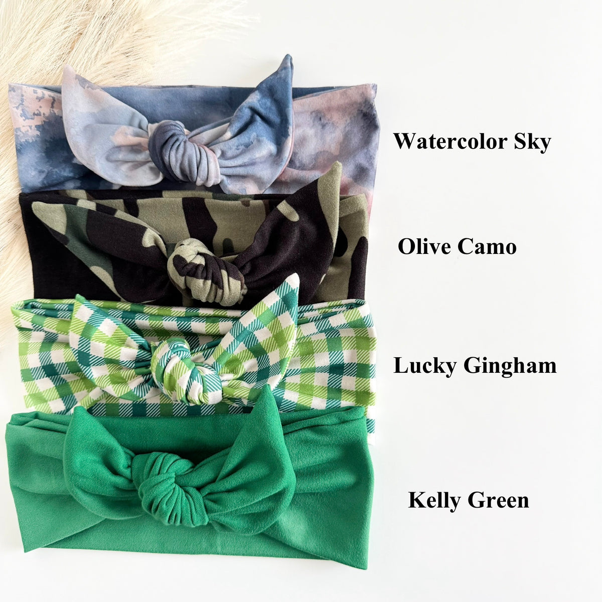 Headband Studio adjustable tie headbands in watercolor sky, olive camo, lucky gingham, and kelly green.