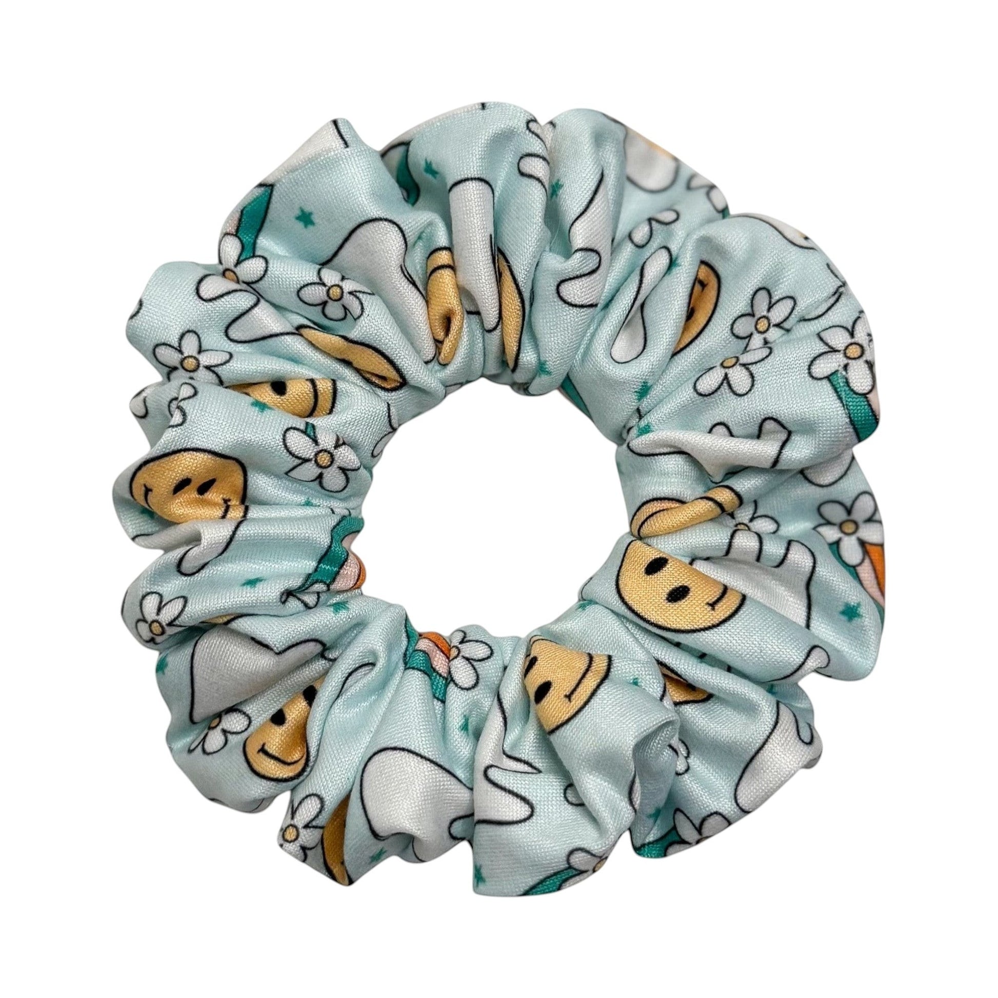 Headband Studio light blue scrunchie with a pattern of smiling teeth and small white flowers, made of soft polyester.