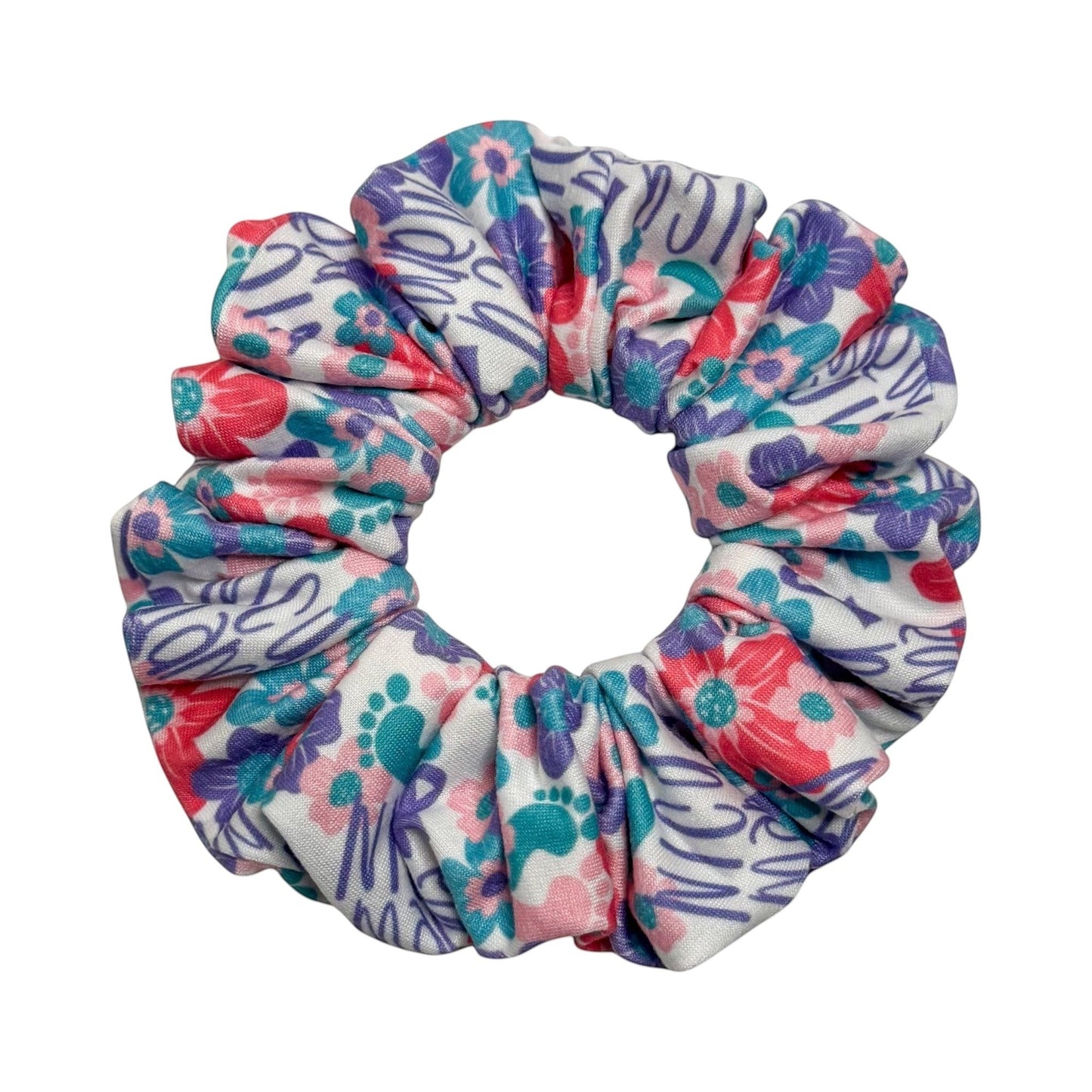 Headband Studio floral and paw print scrunchie with pink, purple, and teal accents. Handmade from soft polyester.