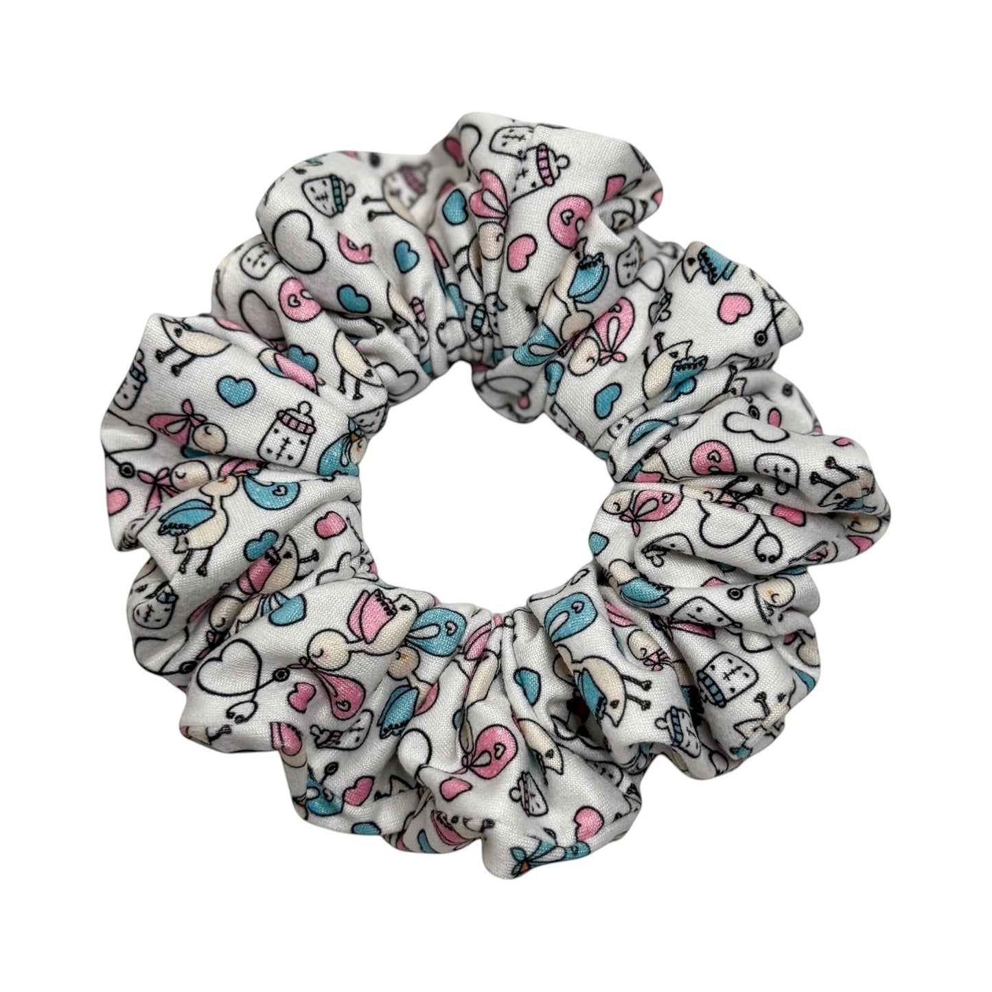 Headband Studio white scrunchie with a playful medical print featuring baby bottles, hearts, and birds in pink and blue.