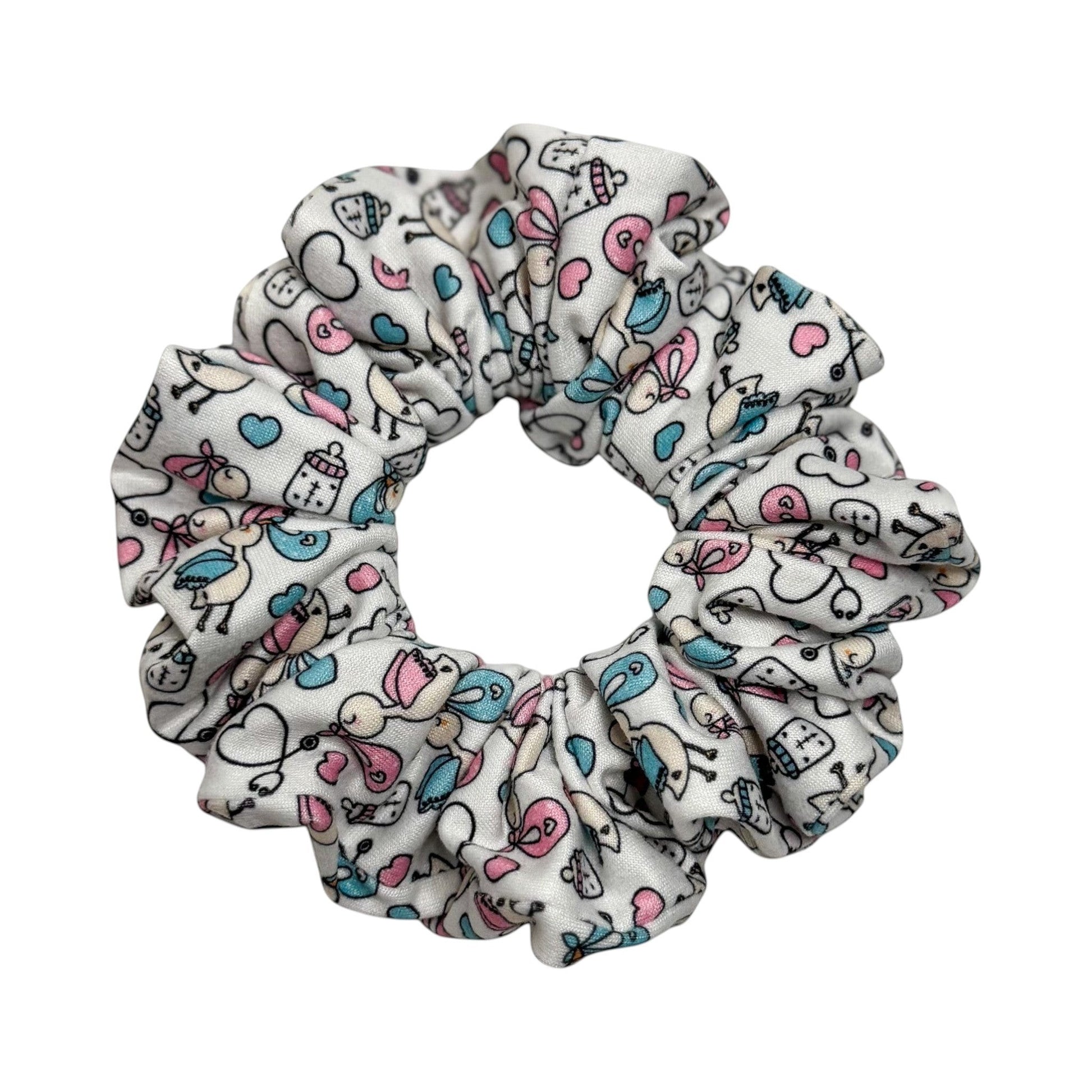 Headband Studio white scrunchie with a playful medical print featuring baby bottles, hearts, and birds in pink and blue.