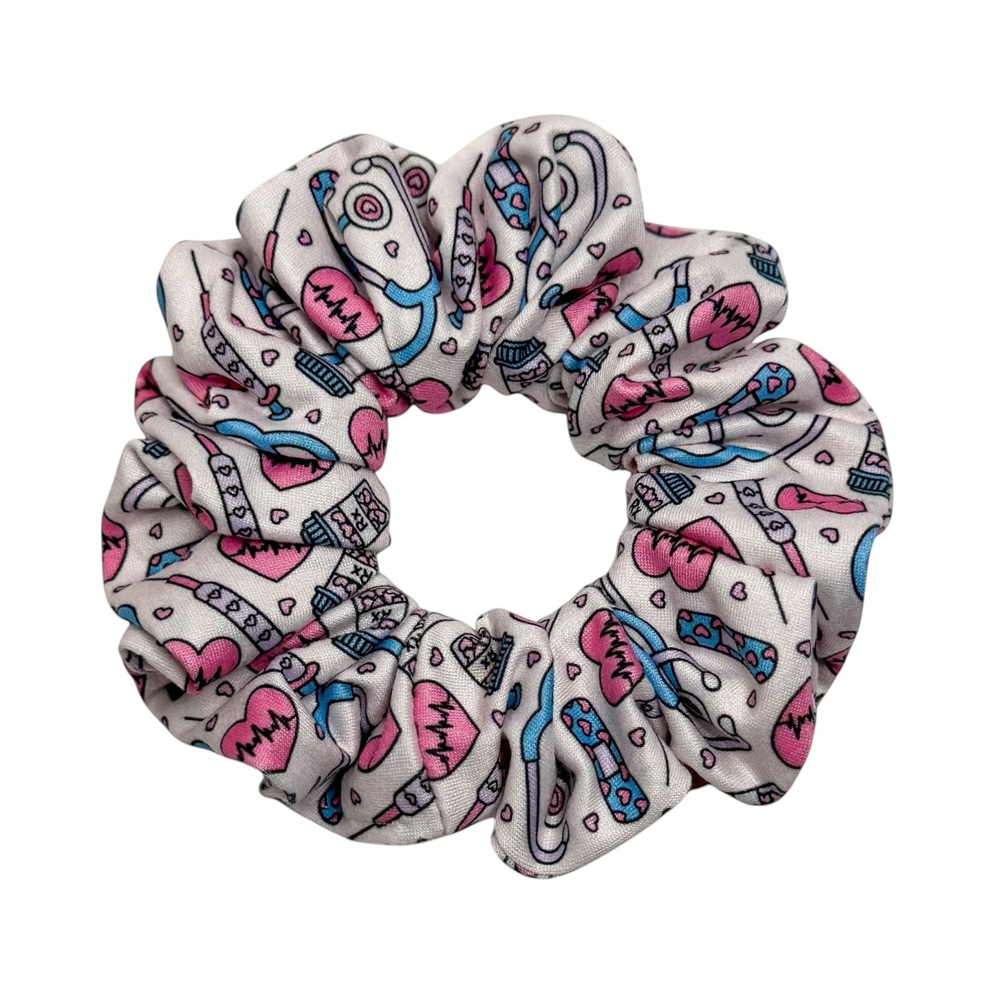 Headband Studio white scrunchie with pink and blue medical icons including stethoscopes, heartbeats, and syringes.