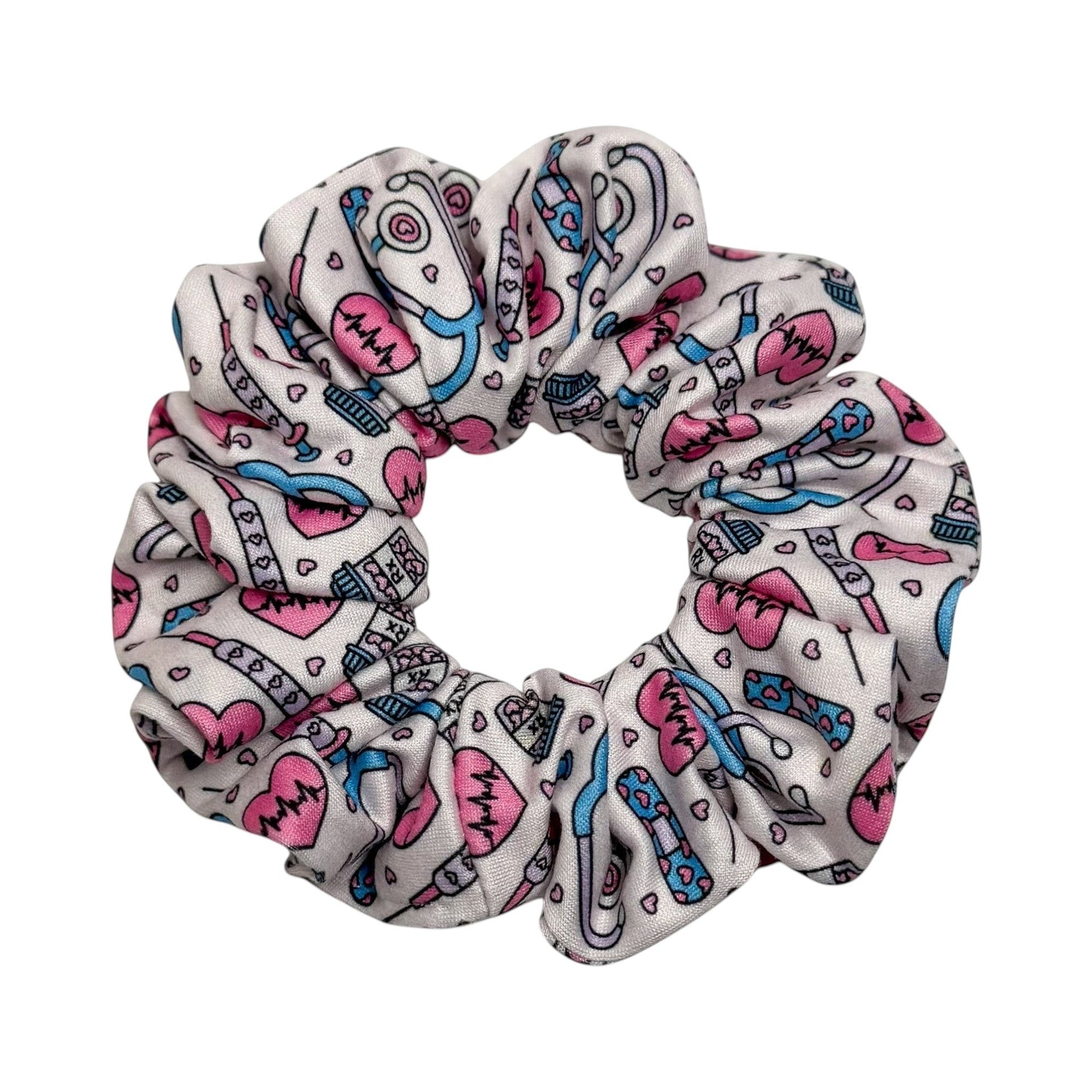 Headband Studio white scrunchie with pink and blue medical icons including stethoscopes, heartbeats, and syringes.
