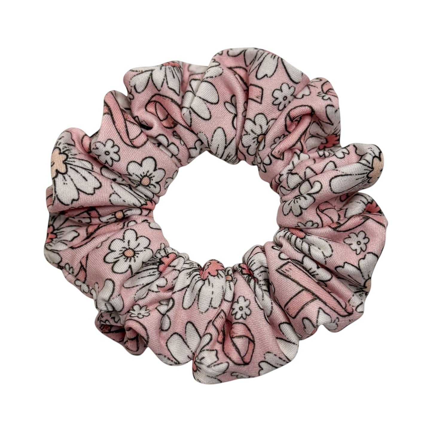 Headband Studio pink scrunchie with a white floral print and black outlines, made of soft polyester.
