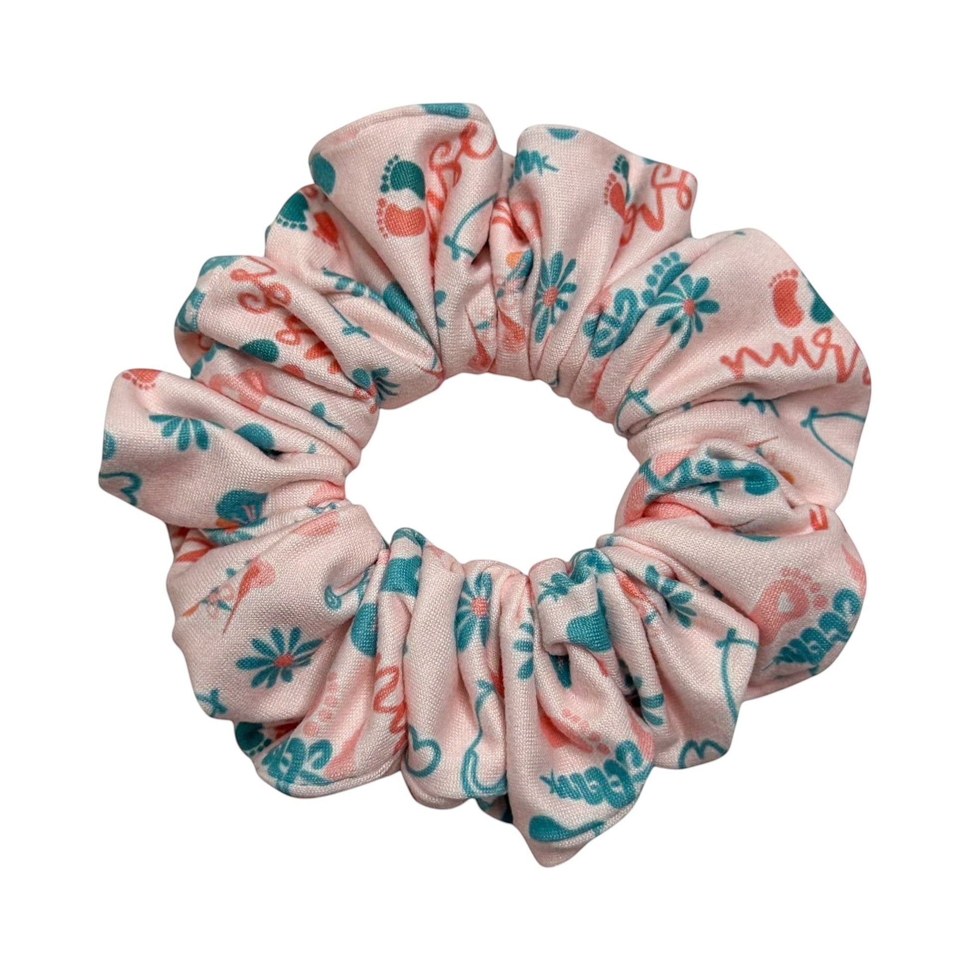 Headband Studio pink scrunchie with teal and coral medical-themed print including footprints and the word "nurse".