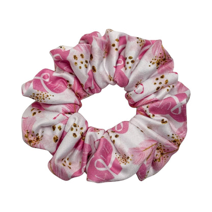 Headband Studio pink and white scrunchie with a stethoscope print and gold accents, made of soft polyester for comfortable all-day wear.