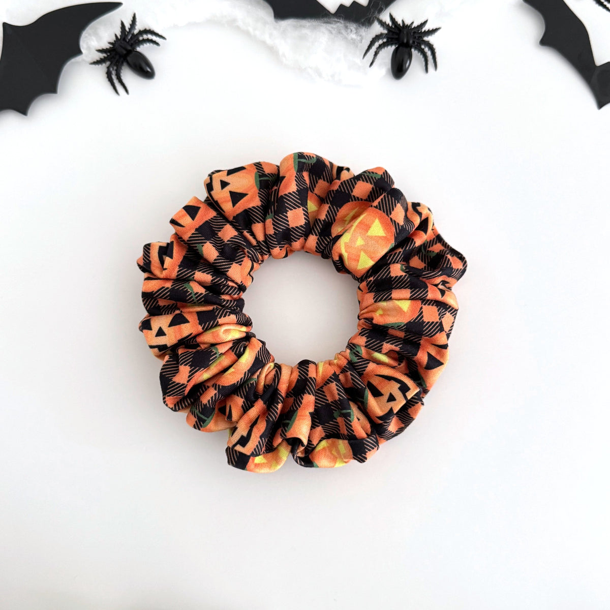 Jack-o'-Lantern Plaid scrunchie with bright jack-o'-lantern faces on orange plaid