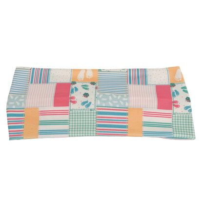 Patchwork fabric panel with colorful squares on a beige background