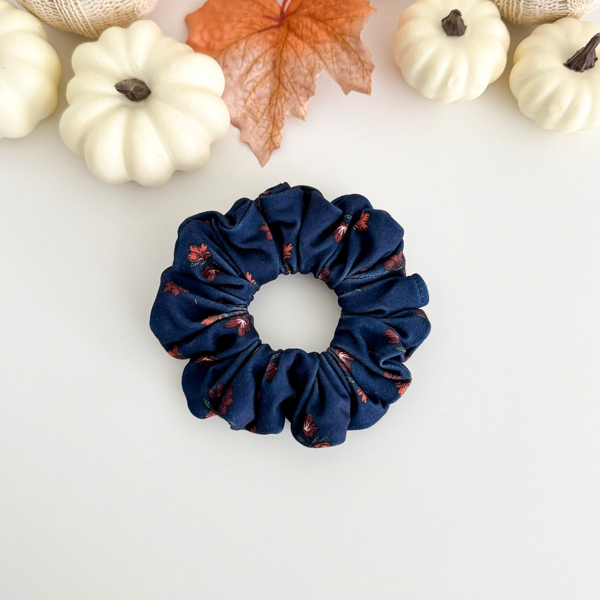 Navy Blossom scrunchie with small rust flowers on navy blue