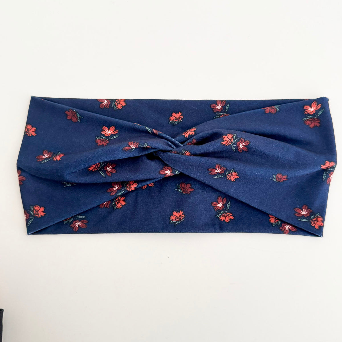 Navy Blossom twist headband with small rust flowers on navy blue