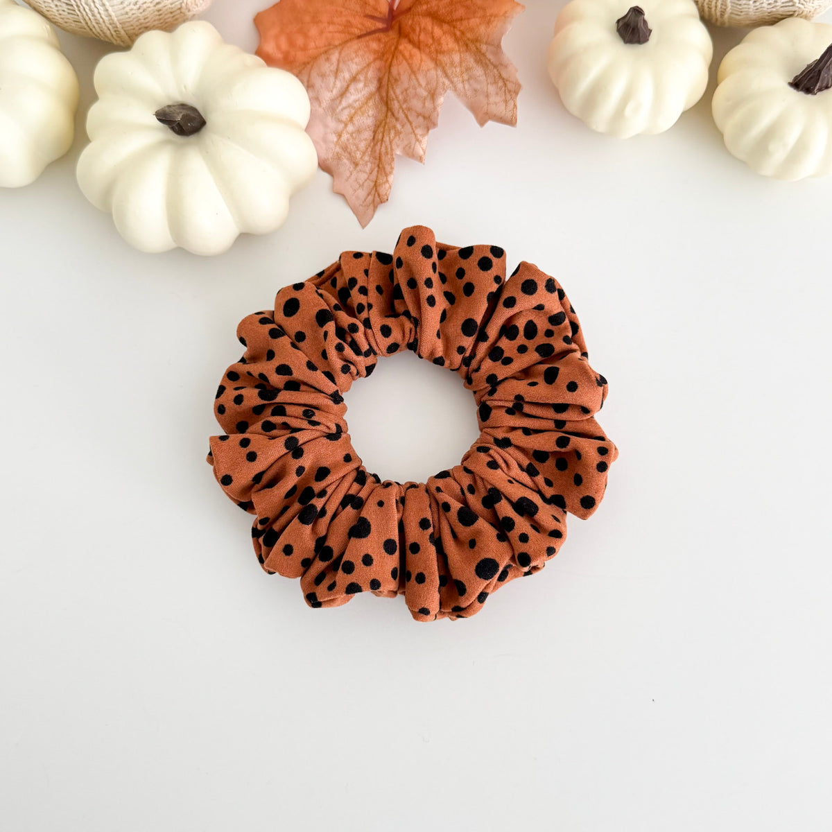 Polka Dot scrunchie with black dots on rust orange