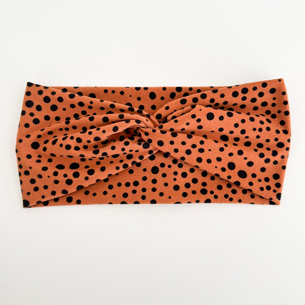 Polka Dot twist headband with black dots on rust orange