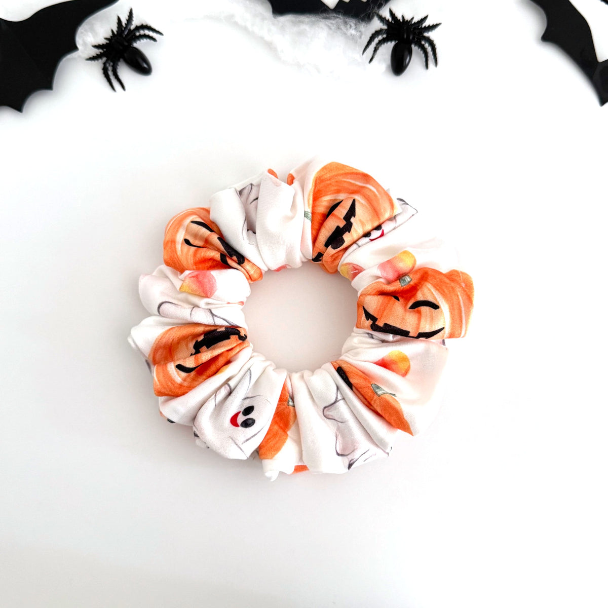 Pumpkin and Candy Corn scrunchie with jack-o'-lanterns, ghosts and candy corn on white