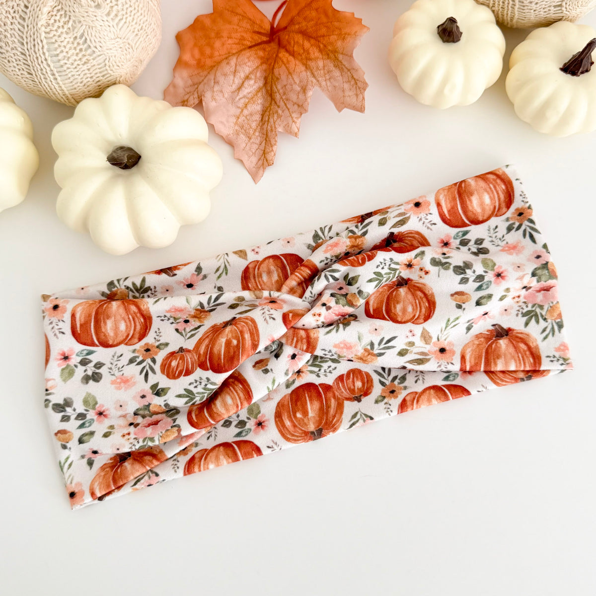 Pumpkin Pink Flowers twist headband styled with white pumpkins and fall leaves
