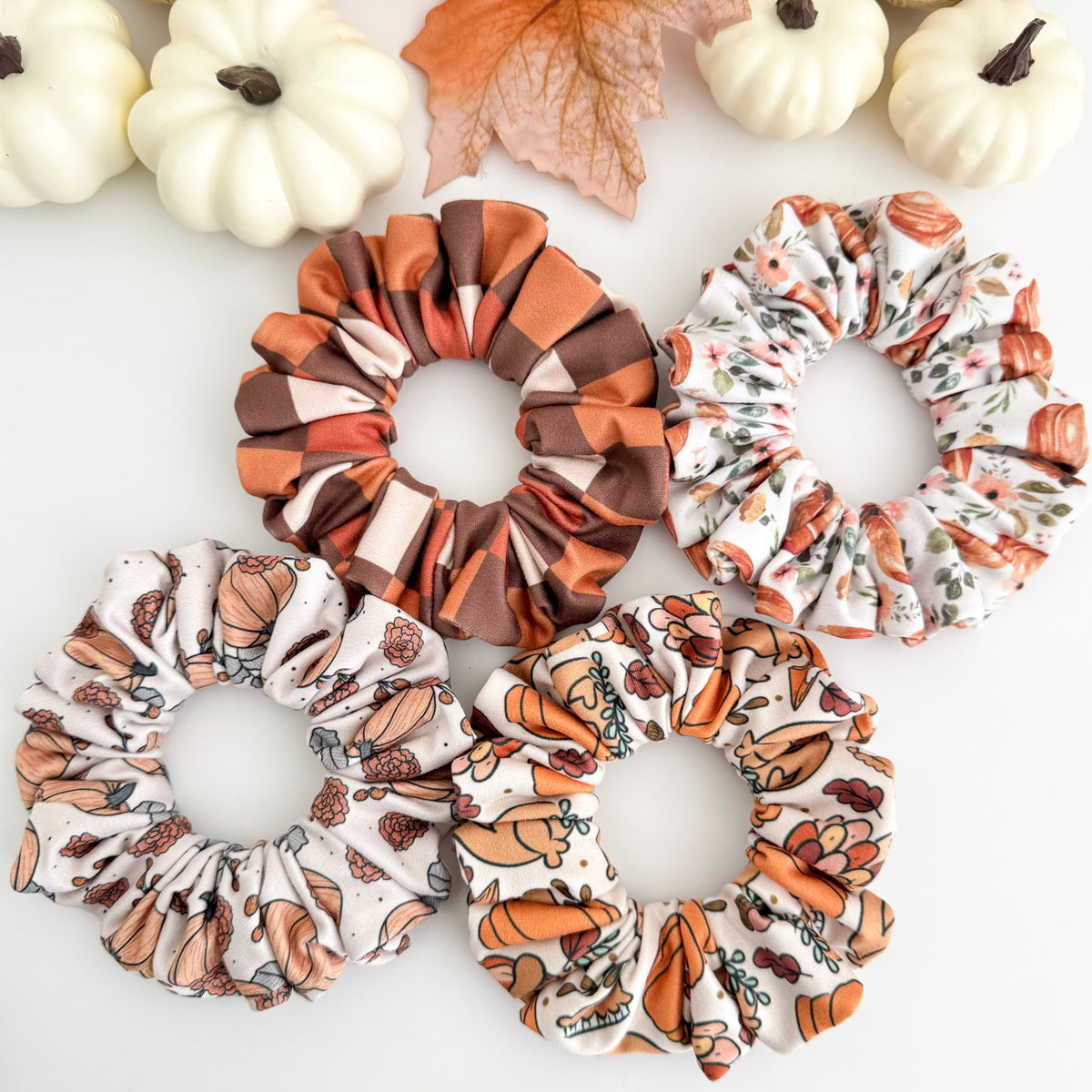 Pumpkin and Thanksgiving scrunchies in Fall Pumpkin, Thanksgiving Feast, Pumpkin Pink Flowers and Brown Checkers prints with white pumpkins