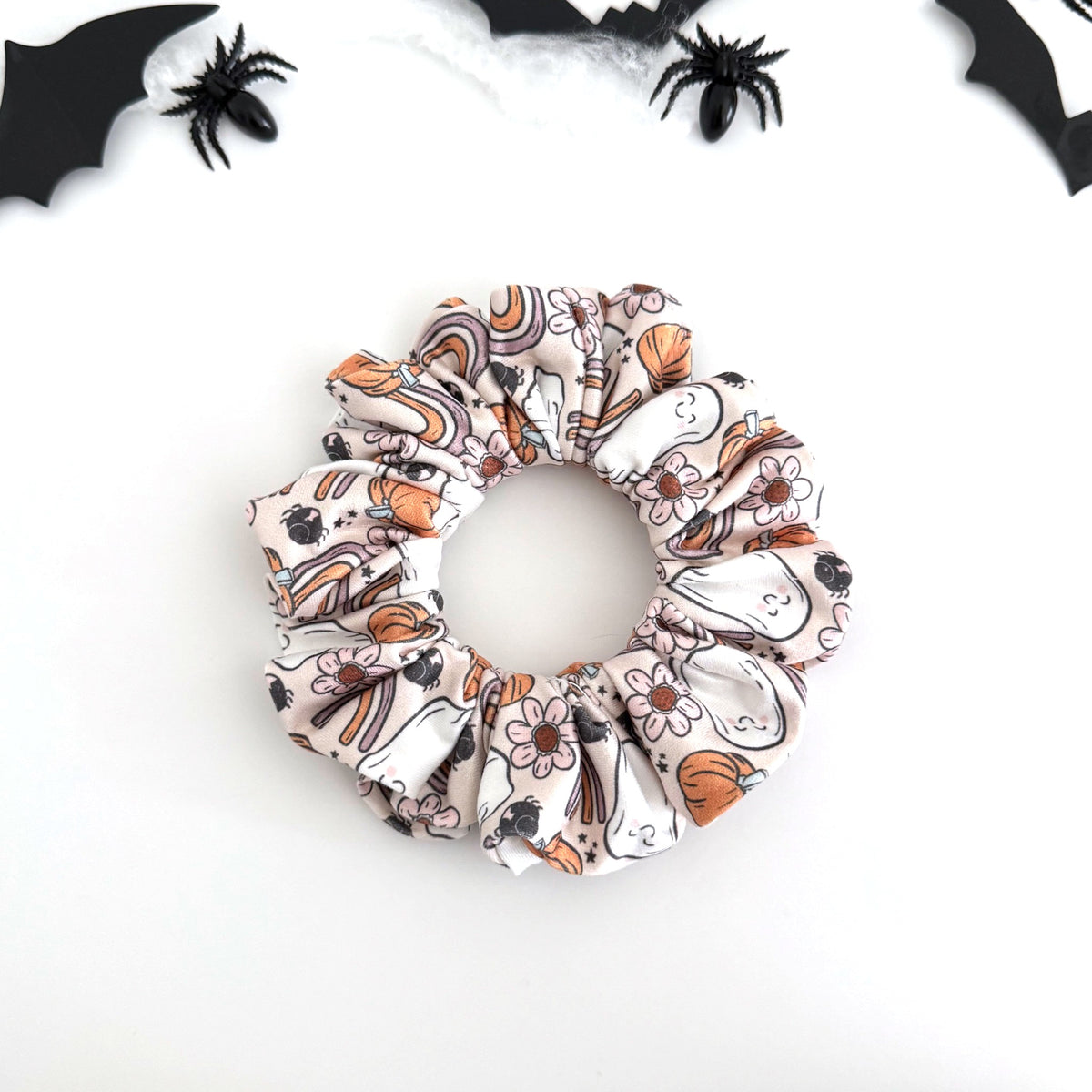 Retro Rainbow Ghost scrunchie with ghosts, rainbows, daisies and pumpkins on cream