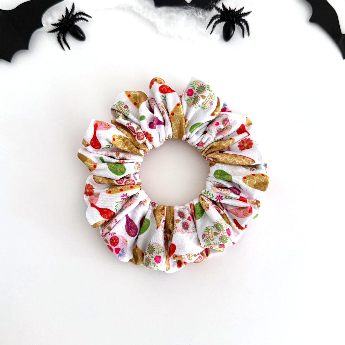Sombreros and Maracas scrunchie with sombreros, maracas and sugar skulls on white