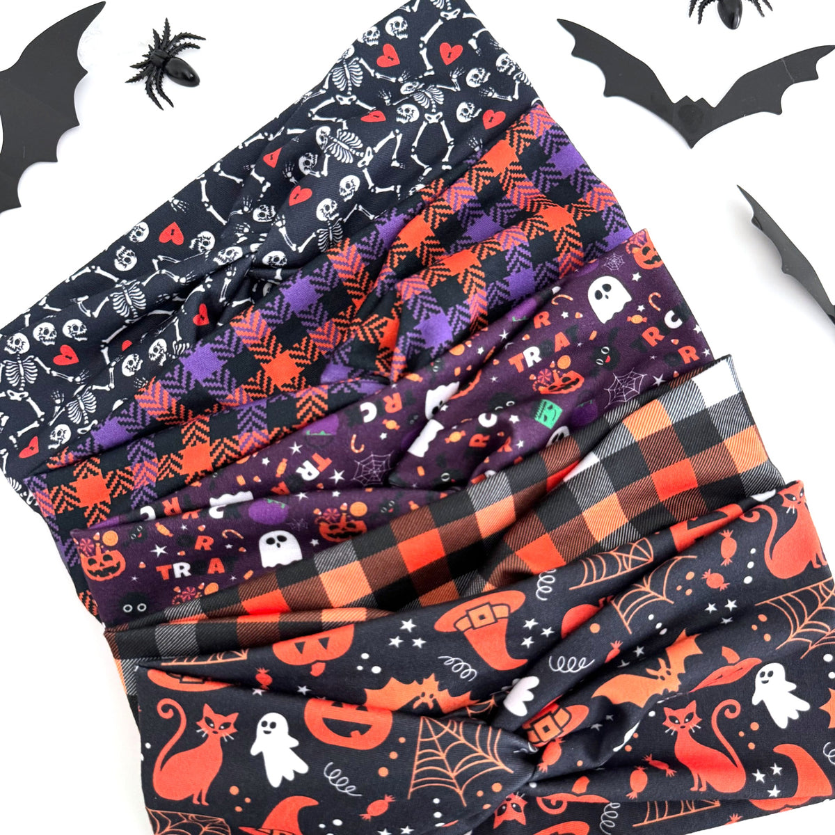 Spooky Night Halloween twist headbands fanned out with paper bats and spiders