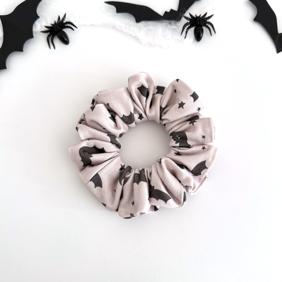 Starry Bats scrunchie with black bats and stars on soft gray