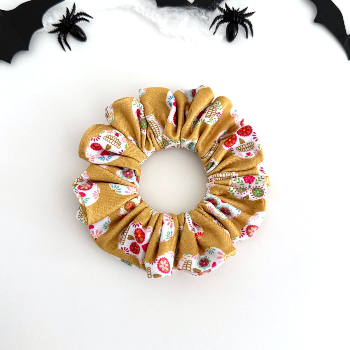 Sugar Skulls scrunchie with floral sugar skulls on mustard gold